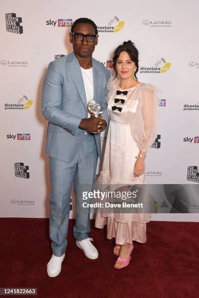 David Harewood, accepting the Theatre award on behalf of "Best Of Enemies", and Phoebe Fox pose in the winners room at the South Bank Sky Arts Awards...