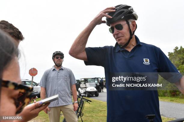 President Joe Biden stops to talk to reporters during a bike ride in Gordons Pond State Park in Rehoboth Beach, Delaware on July 10, 2022. / "The...