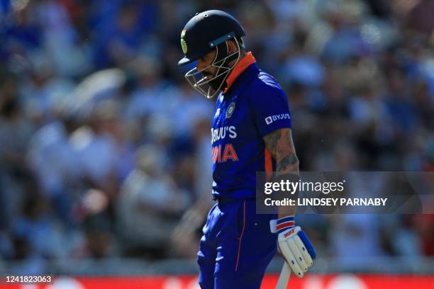 India's Virat Kohli reacts as he walks back to the pavilion after losing his wicket for 11 during the '3rd Vitality IT20' Twenty20 International...