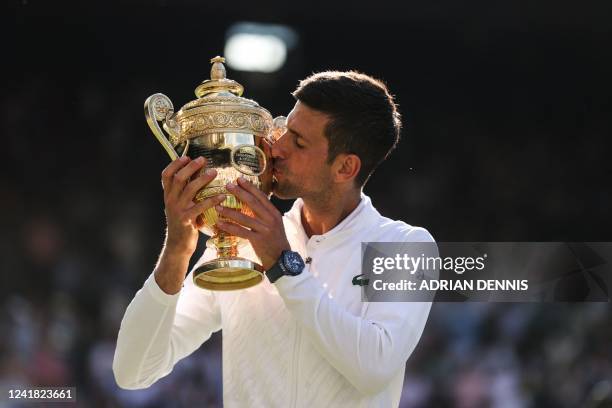 Serbia's Novak Djokovic kisses his trophy after defeating Australia's Nick Kyrgios during the men's singles final tennis match on the fourteenth day...