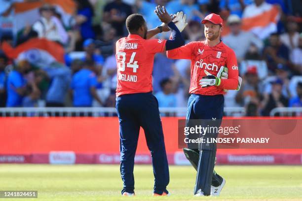 England's Chris Jordan and England's Jos Buttler celebrate their win in the '3rd Vitality IT20' Twenty20 International cricket match between England...