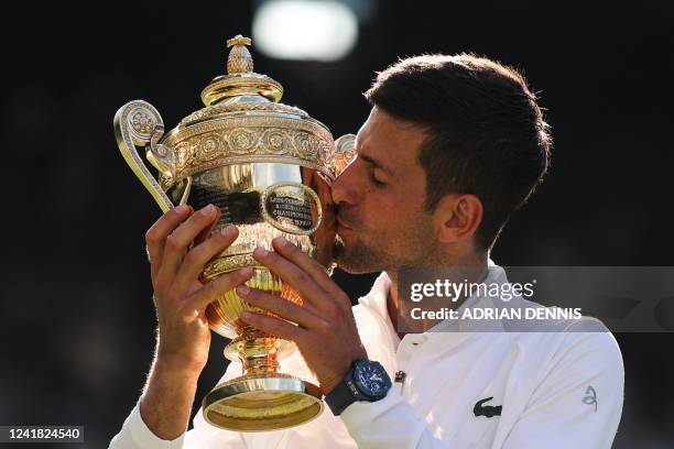 Serbia's Novak Djokovic kisses his trophy after defeating Australia's Nick Kyrgios during the men's singles final tennis match on the fourteenth day...