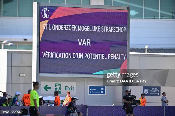 Led boarding is showing 'stil onderzoek mogelijke strafschop VAR verification d'un potentiel penalty' on it during a game between Belgium's national...