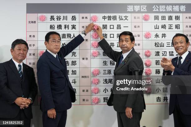 Fumio Kishida , Japan's prime minister and president of the Liberal Democratic Party , place a rose on an LDP candidate's name, with his partyâs...
