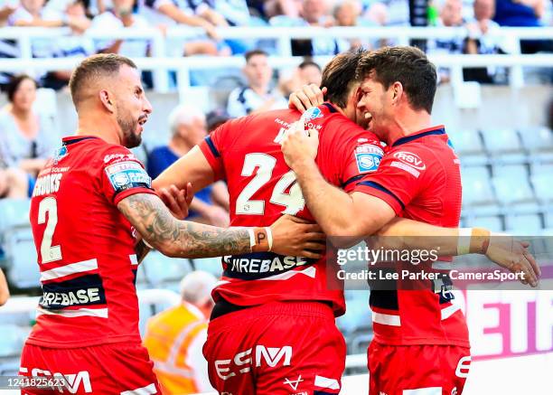 Sam Wood of Hull Fc is congratulated by Lachlan Coote and Ben Crooks after he scores a try in the 36th minute to make 8-14 during the Betfred Super...