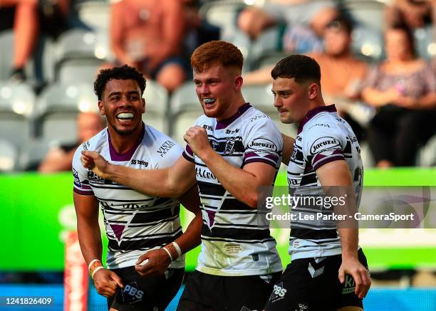 Ellis Longstaff of Hull FC celebrates with Darnell McIntosh and Connor Wynn after he scores a try in the 40th minute to make it 14-18 during the...