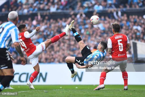 Gabriel Hauche of Racing Club performs a bicycle kick and scores the first goal of his team during a match between Racing Club and Independiente as...