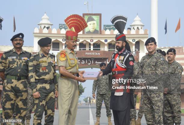 Indian Border Security Force soldier receives sweets from Pakistan's Rangers soldier on the occasion of the Eid ul-Adha at the India-Pakistan Wagah...