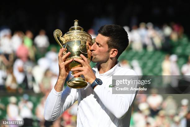 Gentlemen's Singles Final Novak Djokovic v Nick Kyrgios - Novak Djokovic celebrates victory by holding the trophy during day fourteen of The...