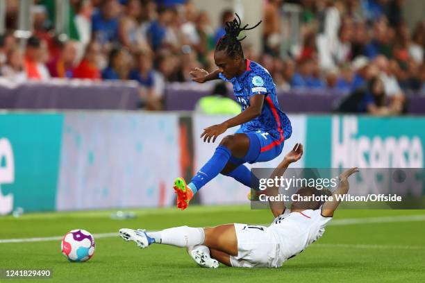 Melvine Malard of France jumps over a slide tackle from Lisa Boattin of Italy during the UEFA Women's Euro England 2022 group D match between France...