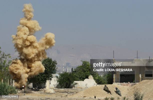 An explosion is provoked as Syrian soldiers take part in a training session to remove and neutralise unexploded weapons, in the countryside of the...