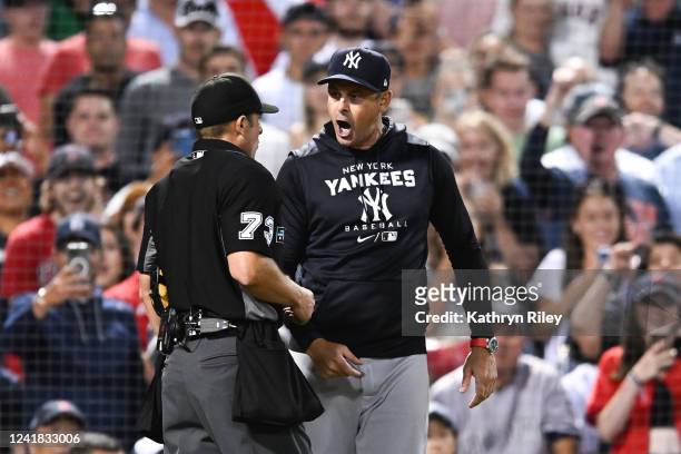 Manager Aaron Boone of the New York Yankees yells at home plate umpire Tripp Gibson in the seventh inning against the Boston Red Sox at Fenway Park...