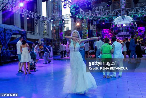 Couples dance after getting married during a mass wedding for covid-delayed couples at Lincoln Center in New York City on July 10, 2022. Just married...