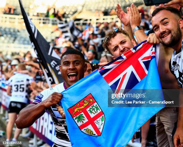 Joe Lovodua of Hull FC holds up the Fijian flag as he celebrates the victory at the end of the match during the Betfred Super League Magic Weekend...