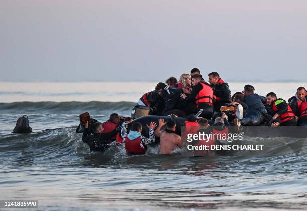 About fourty migrants, fom various origins, board an inflatable boat before they attempt to cross the Channel illegally to Britain, near the northern...