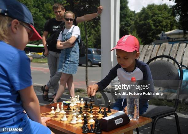 Five-year-old chess prodigy Artem Kucher plays chess with a boy during a charity match in support of the Ukrainian Armed Forces in Kostiantyna...