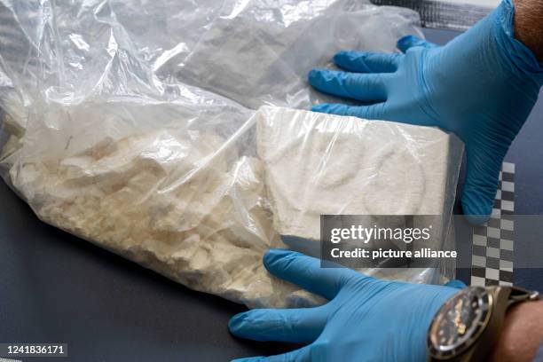 July 2022, Bavaria, Munich: A customs officer presents part of what has become the largest single seizure of cocaine in Bavaria to date....