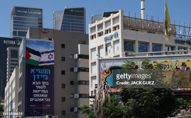 Billboard by Israeli anti-occupation group Peace Now, welcoming US President Joe Biden, hangs on a building in the coastal city of Tel Aviv on July...