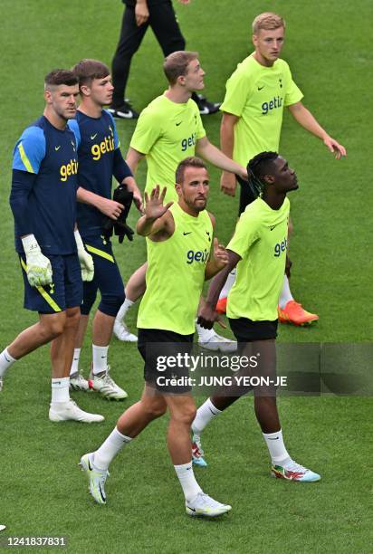 Tottenham Hotspur's Harry Kane waves to fans during an open training session at Seoul World Cup Stadium in Seoul on July 11 on their football...