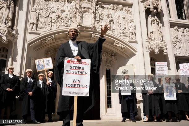 Junior Barrister Leon Lynch of 25 Bedford Chambers speaks to other barristers as they continue their strike action with a protest outside the Supreme...