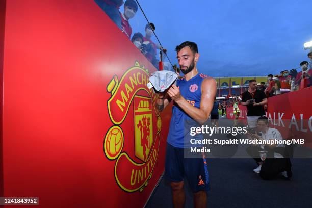 Bruno Fernandes of Manchester United signs autographs for fans after a training session ahead of the preseason friendly match between Liverpool and...