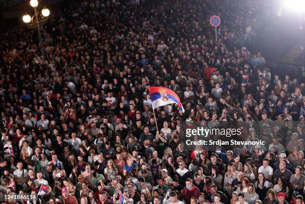 Supporters of Serbian tennis player Novak Djokovic wave Serbian flags during the welcoming ceremony in front of Belgrade City Hall on July 11, 2022...