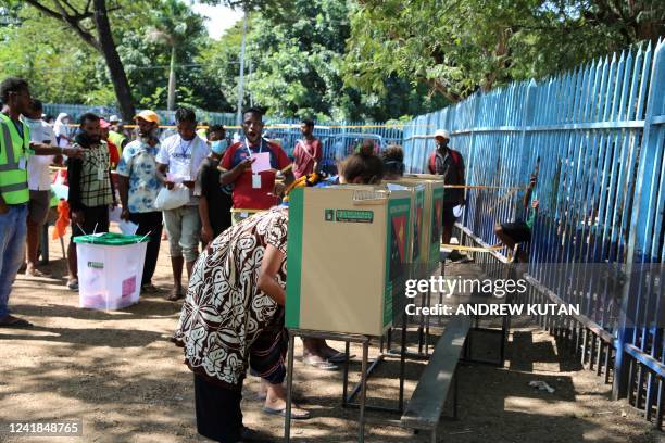 This picture taken on July 11 shows voters casting their votes at a polling station in the general elections in Papua New Guinea's capital city Port...