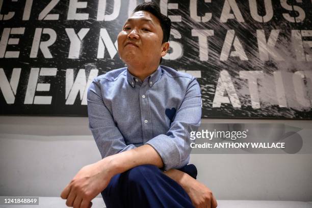 In this picture taken on May 27 South Korean rapper Psy poses during an interview with AFP, in a dance studio at his record label and entertainment...