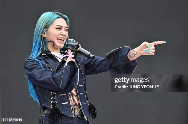 This picture taken on June 19, 2022 shows Korean American K-pop star AleXa performing on a stage before a red carpet event for the film 'Top Gun:...