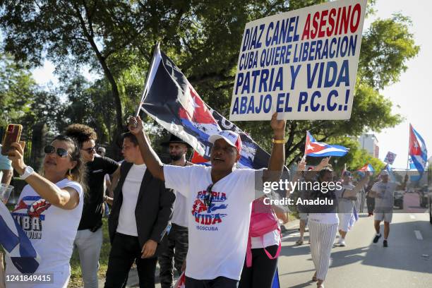 Protesters are seen during a gathering in Miami to support the freedom of the Cuban people as they commemorate the first anniversary of the July 11th...