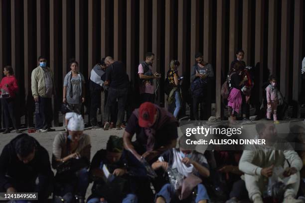 Migrants wait to be processed by US Border Patrol after illegally crossing the US-Mexico border in Yuma, Arizona in the early morning of July 11,...