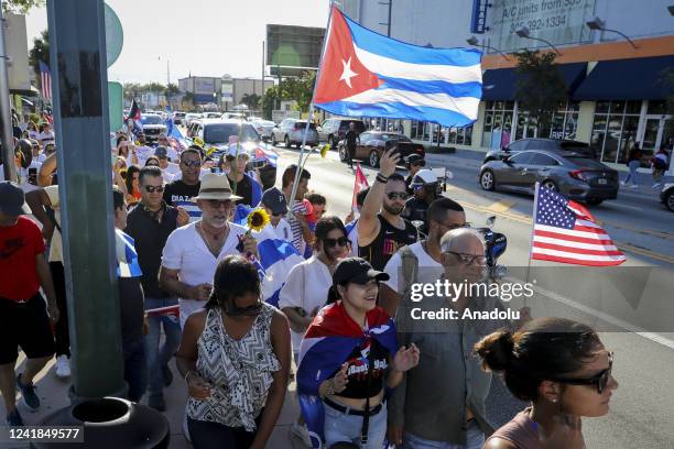Protesters are seen during a gathering in Miami to support the freedom of the Cuban people as they commemorate the first anniversary of the July 11th...