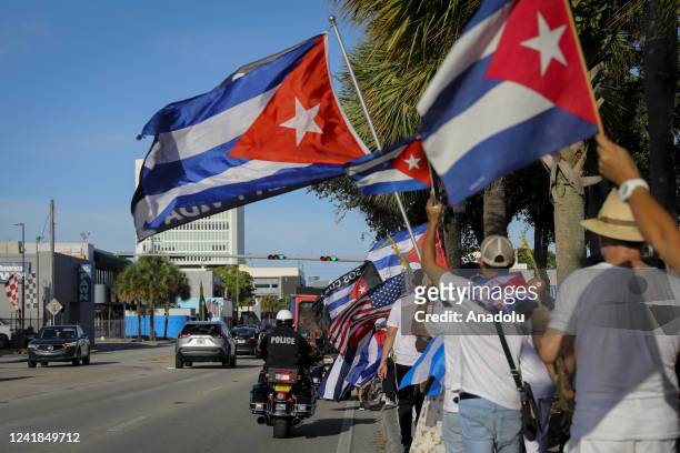 Protesters are seen during a gathering in Miami to support the freedom of the Cuban people as they commemorate the first anniversary of the July 11th...