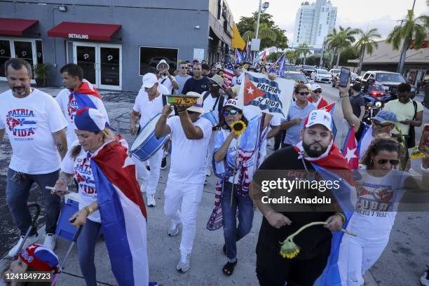 Protesters are seen during a gathering in Miami to support the freedom of the Cuban people as they commemorate the first anniversary of the July 11th...