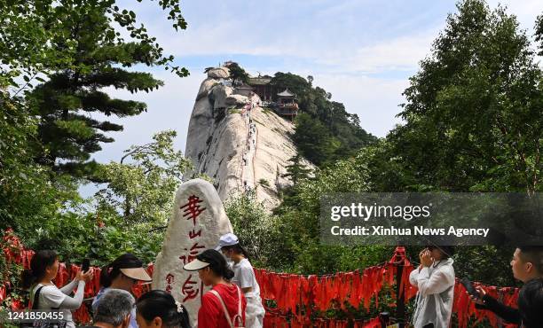 People visit the scenic spot of Mount Huashan in northwest China's Shaanxi Province, July 10, 2022. Mount Huashan is one of China's five most famous...