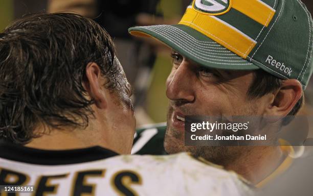 Aaron Rodgers of the Green Bay Packers talks with Drew Brees of the New Orleans Saints after the NFL opening season game at Lambeau Field on...