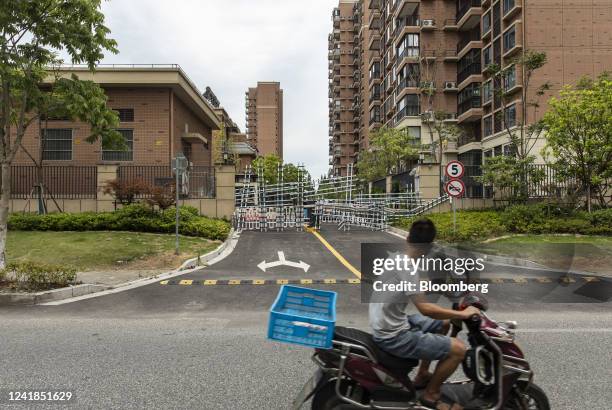 Barricades from recent Covid-related lockdowns block an entrance leading to Country Garden Holdings Co.'s Fengming Haishang residential development...