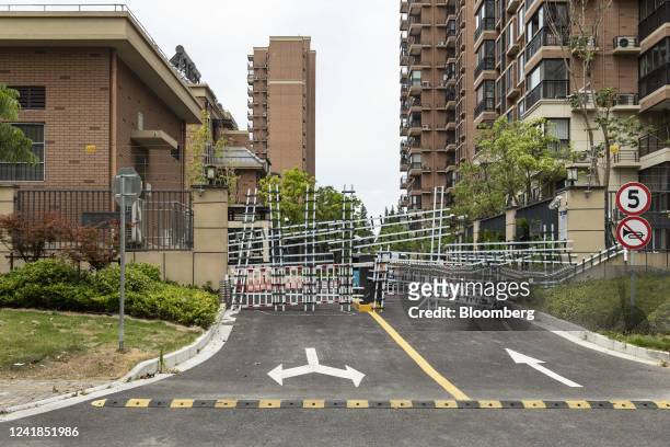 Barricades from recent Covid-related lockdowns block an entrance leading to Country Garden Holdings Co.'s Fengming Haishang residential development...
