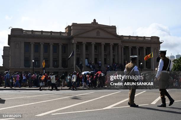 People line up to visit presidential secretariat in Colombo on July 12 after it was overrun by anti-government protestors. - Sri Lanka's President...