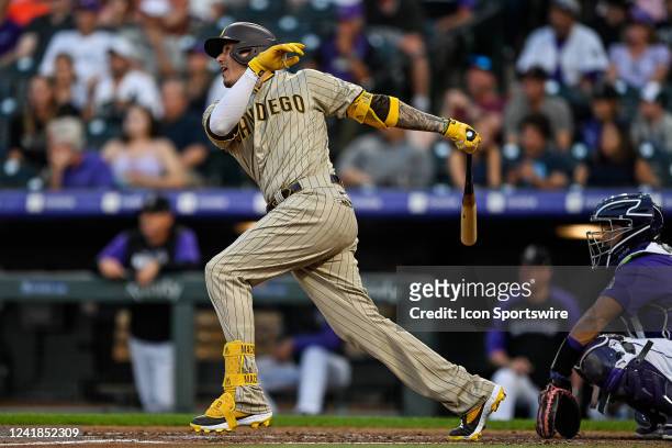 San Diego Padres third baseman Manny Machado hits a fifth inning single during a game between the San Diego Padres and the Colorado Rockies at Coors...
