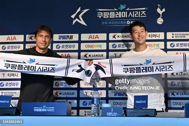 Tottenham Hotspur's South Korean striker Son Heung-min and head coach Antonio Conte pose for a photo during a pre-match press conference ahead of the...