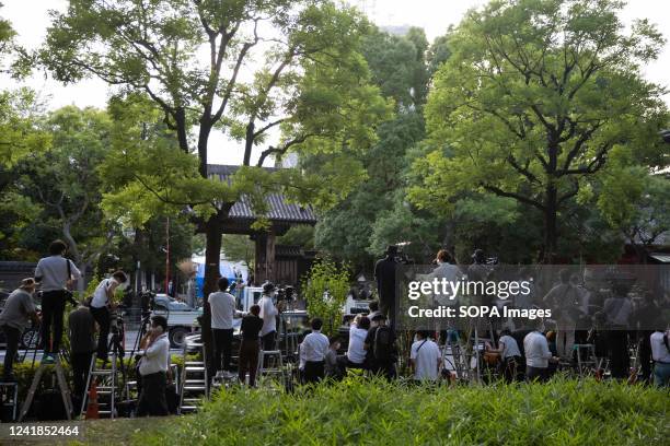 Media reports on the vigil of assassinated former Japanese Prime Minister Shinzo Abe from across Zojoji Temple at a nearby park after being denied...