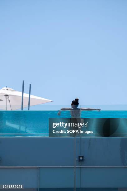 Person is immersed in the swimming pool of Hotel W on the beach of San Sebastian. The second wave of extreme heat may exceed 44 degrees Celsius in...