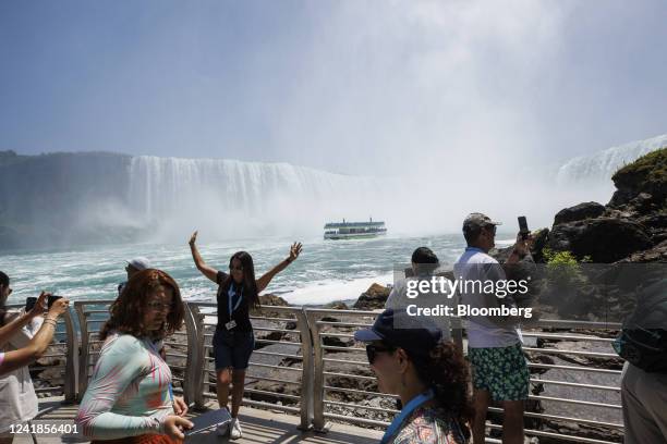 Tourists visit a viewing platform outside The Tunnel at the Niagara Parks Power Station in Niagara Falls, Ontario, Canada, on Sunday, July 10, 2022....