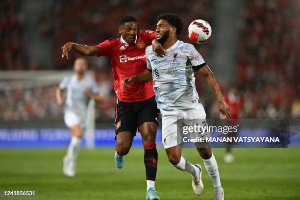 Manchester United's French striker Anthony Martial and Liverpool's English defender Joe Gomez battle for the ball during the exhibition football...