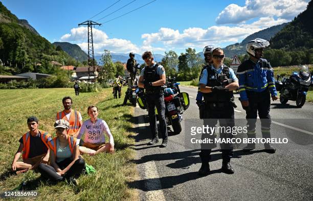 French gendarmes stand by environmental protestors of the movement "Derniere Renovation" after their protest action temporarily immobilized the pack...