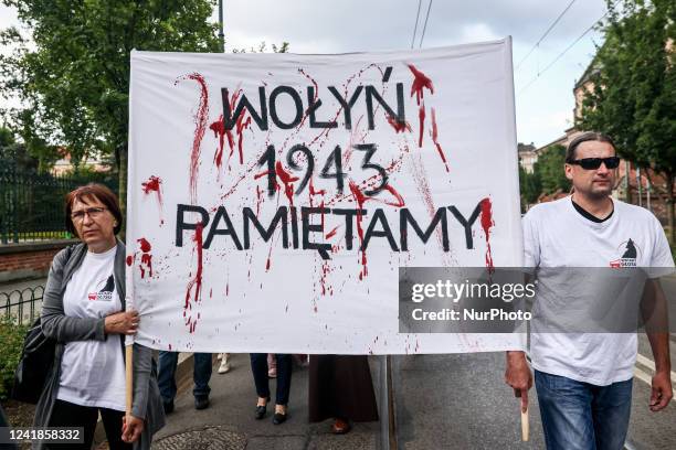People hold a banner reading 'Volhynia. 1943. We remember.' during a commemoration service of Polish victims of Ukrainian genocide commited in...