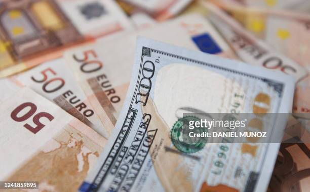 Dollar bill is seen on top of Euro bills in Bogota, on July 12, 2022. The euro struck parity with the dollar for the first time in nearly 20 years on...