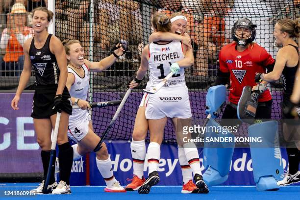 Nike Lorenz, Pia Maertens and Lena Micheel of Germany celebrate during the quarter-final match between New Zealand and Germany of the World Hockey...