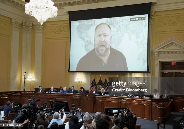 Video of Alex Jones, radio host and creator of the website InfoWars, is played on a screen during a hearing of the Select Committee to Investigate...